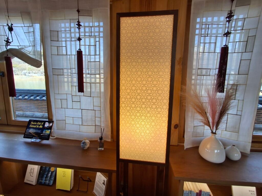 Traditional window with hanji curtain and warm lighting inside Yeonhwajeong Library in Jeonju